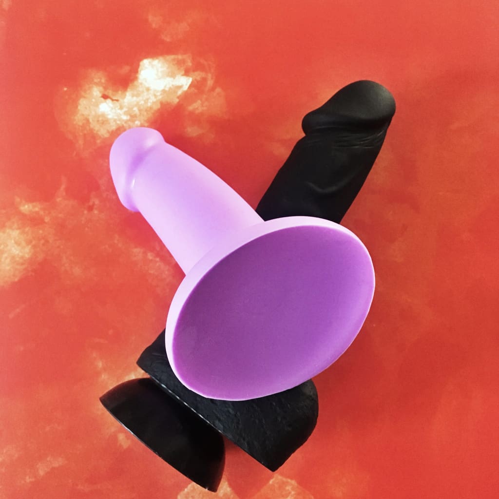 view of purple dildo atop the black cloud9 dildo